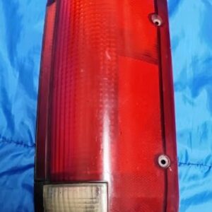 "Front view of 1988-1998 Chevy GMC OBS passenger side tail light with red lens and clear bottom reverse section"