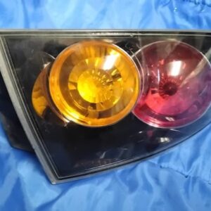 "Angled front view of 2004-2009 Mazda 3 Sedan left hand outer tail light housing assembly"