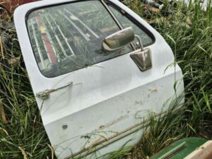 Driver side door for a 1973–1987 Chevy or GMC Square Body truck, white finish, features manual window setup and stainless mirror