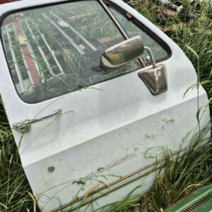 Driver side door for a 1973–1987 Chevy or GMC Square Body truck, white finish, features manual window setup and stainless mirror