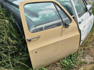 Driver side door shell for a 1973–1987 Chevy or GMC Square Body truck, tan finish, manual windows, includes glass, features speaker hole modification, door panel excluded