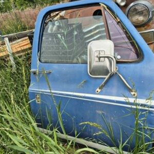 "Driver side door for a 1973–1987 Chevy or GMC Square Body truck, blue finish with pinstripes, manual windows, tripod mirror, requires minor body work on front edge, as seen
