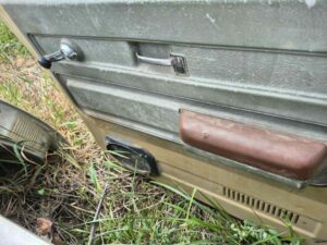 Driver side door shell for a 1973–1987 Chevy or GMC Square Body truck, tan finish, manual windows, includes glass, features speaker hole modification, door panel excluded