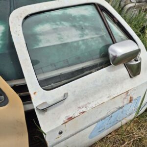 "Passenger side door for a 1973–1987 Chevy or GMC Square Body truck, white finish with graphics, features manual window setup, stainless mirror, and minor body filler work