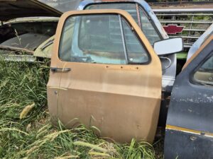 Passenger side door for a 1973–1987 Chevy or GMC Square Body truck, tan finish, manual window setup,