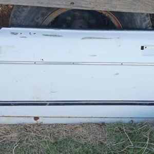 Genuine OEM driver's side (LH) door shell for first-generation Subaru Brat (1978–1981). Features original white finish and classic dual-strip body molding.