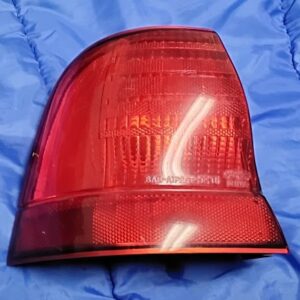 Replace your broken or faded outer tail lamp with this OEM Right Hand (Passenger Side) Outer Quarter Panel Corner Taillight Light Assembly for the 10th-Generation MN12 1992–1995 Ford Thunderbird. This is the outer corner lamp unit that mounts to the rear quarter panel (adjacent to the trunk lid center reflector section). Key Features & Details: Fitment: 1992–1995 Ford Thunderbird (Right / Passenger Side Outer Corner) Lens Stamping: SAE-AIP2ST-92 T1 Housing Part Number Stamped: RH W.M.P. CAV 2 / F2SB13B414AF (F2SB-13B414-AF) Condition: Original factory pre-owned part. Clean red lens face free of major cracks. Back housing includes mounting studs/hardware and bulb socket weather seal gasket as pictured. Note: Please verify part numbers, SAE codes, and housing geometry against your vehicle's original part to ensure complete compatibility.