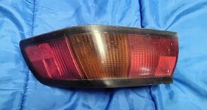 OEM 1987-1991 Toyota Camry Sedan driver side left outer tail light assembly front lens view