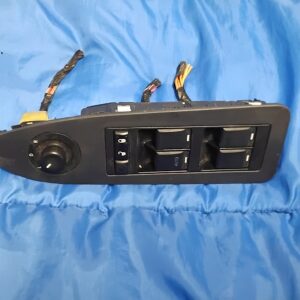 Top view of 2005-2010 Chrysler 300 driver master power window switch, door lock, and mirror control dial in bezel