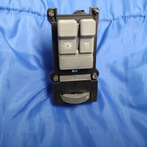 Straight-on front view of grey 1988-1994 GM truck headlight rocker switches and lower thumbwheel dimmer