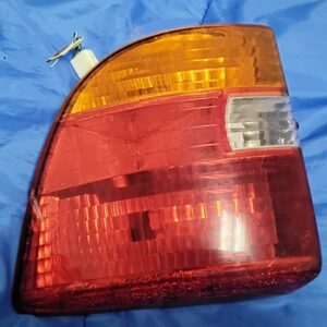 OEM 2000-2005 Toyota Celica driver side left tail light assembly front view showing amber top lens