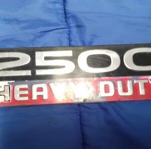 Front view of OEM Dodge Ram 2500 Heavy Duty black and red door fender badge emblem